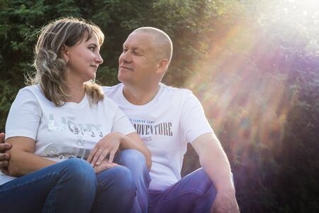 Kirov, Russia - August 21, 2018: Adult couple loving each other in the Park on a Sunny summer day. Ordinary family consisting full man and full woman hug each otherのeditorial素材