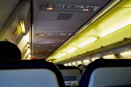 Marmaris, Turkey - May 26, 2018: The cabin of airplane with passengers with emergency lightingin...