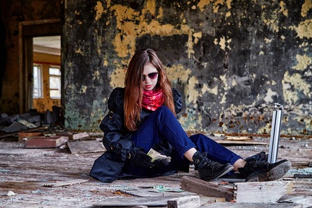 Girl in a black cloak with a diplomat and money in a ruined room. A spy in a secret meeting. Unusual photoshootの写真素材