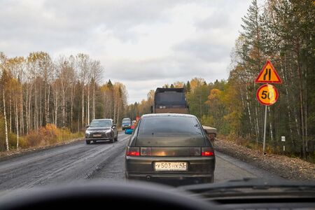 Kostroma, Russia-October 03, 2018: View of the road repair and repair equipment from the car window