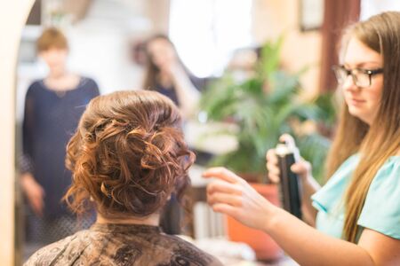 Kirov, Russia - June 15, 2018: Fat barber makes hairstyle for plump bride from Russiaのeditorial素材