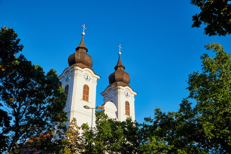 The two clock towers of the famous Benedictine Monastery of Tihany Abbey in a summer evening