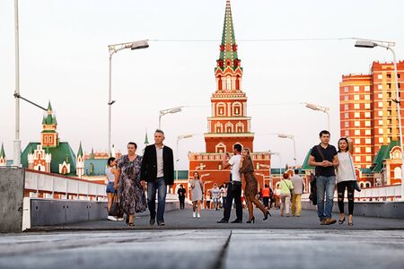 Yoshkar-Ola city, Republic of Mari El, Russia - August 30, 2018: View of the Blagoveshchenskaya Spasskaya Tower and people walking on the square of Yoshkar-Ola city in Russiaのeditorial素材