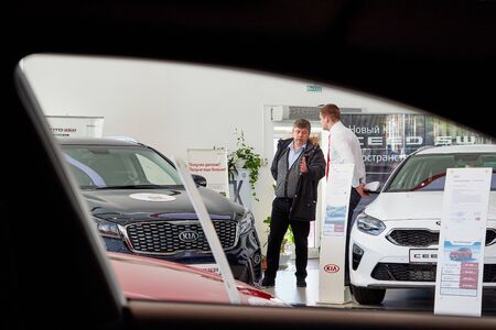 Kirov, Russia - March 07, 2019: Manager and buyer in showroom of dealership Kia in Kirov city in...