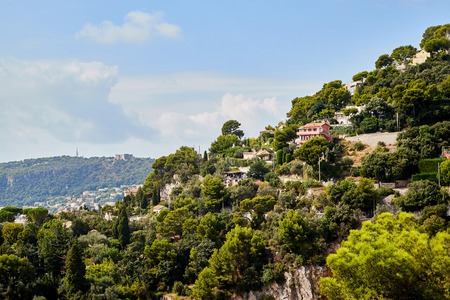 Small village on the mountainside in a Sunny summer day. Top of mountain and blue sky backgroundの写真素材