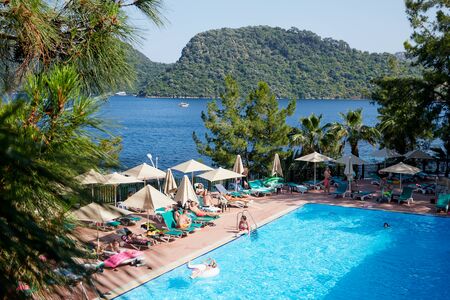 Marmaris, Turkey - May 23, 2018: Swimming pool in hotel and people are enjoying sunny weather on sunbed near it. Top viewのeditorial素材