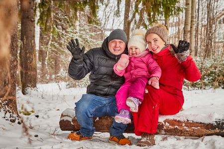 Happy family walking in the forest in a winter dayの写真素材