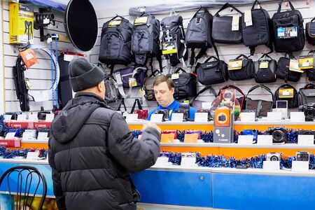 Kirov, Russia - February 15, 2018: Seller and buyer in the store of photographic equipment in Russiaのeditorial素材