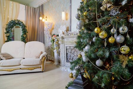 Kirov, Russia - December 17, 2018: Beautiful Christmas living room with decorated Christmas tree, gifts and fireplace. Place for photoshoot in New Yearのeditorial素材