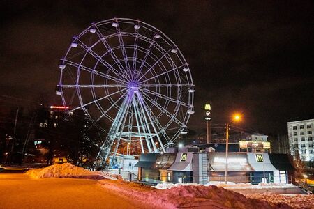 Russia, Kirov - January 06, 2018: Glowing Ferris wheel on a city street on a winter night in the city in Russiaのeditorial素材