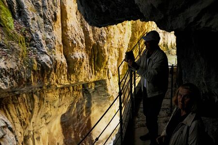 Skocjanske cave, Slovenia - September 26, 2018: Tourists on observation deck in Skocjanski reserve in the mountains. Person during travel looking on beautiful landscapeのeditorial素材