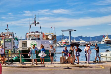 Saint-Tropez, France - September 23, 2018: Yachts at sea and people on the pier near them on a Sunny day. Ships and blue sky with white clouds at the resort placeのeditorial素材