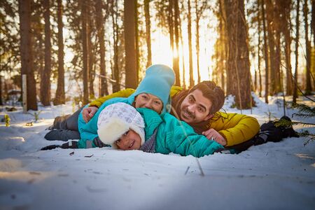 Happy family walking in the forest in a winter dayの写真素材