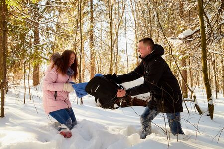 Kirov, Russia - February, 23, 2019: Happy Young Couple having picnic in Winter forest. Family Outdoors. Love, fun, season and people - walking in winter parkのeditorial素材
