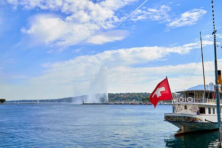 Geneva, Switzeland - September 21, 2018: Panoramic view on famous Jet d'Eau fountain and boat in a nice day with blue sky and clouds in summerのeditorial素材