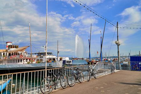 Geneva, Switzeland - September 21, 2018: Panoramic view on sailboats and famous Jet d'Eau fountain...