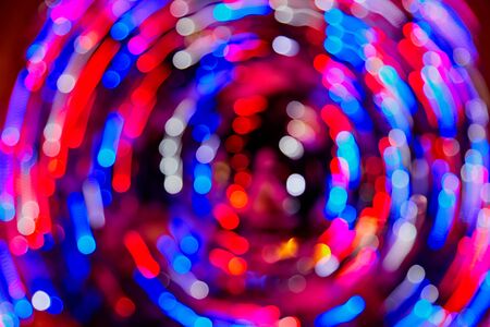 Abstract texture with light round coloured red and blue bokeh and black background. Christmas designeの写真素材