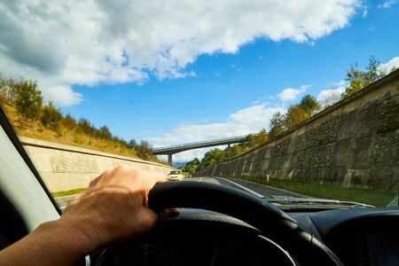 Zakopane, Poland - September 29, 2019: Track from the car window and white clouds on blue sky....