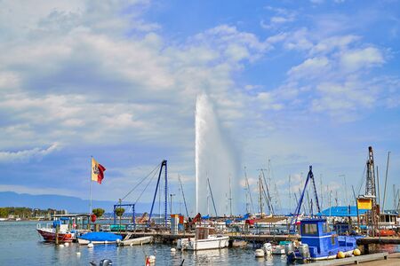 Geneva, Switzeland - September 21, 2018: Panoramic view on sailboats and famous Jet d'Eau fountain in a nice day with blue sky and clouds in summer, Canton of Geneva, Switzerlandのeditorial素材