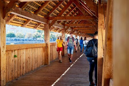 Lucerne, Switzerland - September 20, 2018: Tourists inside of Wooden Chapel Bridge in Lucerne city in Switzerland in a sunny dayのeditorial素材