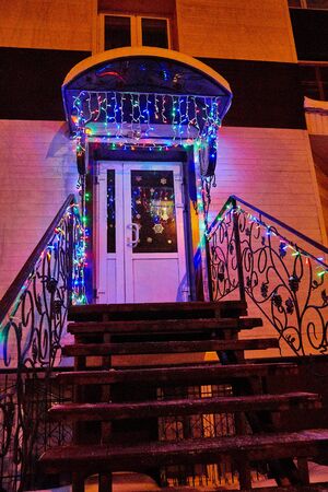 Kirov, Russia - December 28, 2018: Entrance to the store with a glowing sign and glowing garlands at night in winter in Russiaのeditorial素材