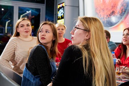 Kirov, Russia - April 18, 2019: People in restaurant waiting something during intellectual game where team give answers to questions. Hungry group waiting for the waiterのeditorial素材