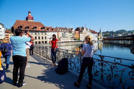 Lucerne, Switzerland - September 20, 2018: Embankment near the wooden bridge and tourists in Lucerne city in Switzerlandのeditorial素材
