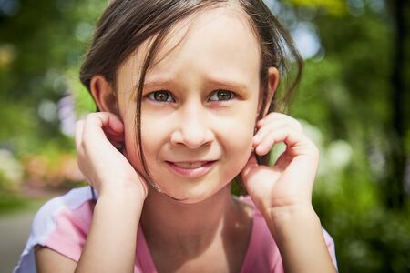 Little beautiful girl on nature in the park. Happy childhood in a summer dayの写真素材