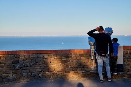 Tihany, Hungary - September 27, 2018: View of the Lake Balaton from Tihany on a sunny day. Tourists on the high shore of lake Balaton at sunsetのeditorial素材
