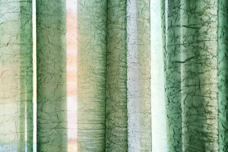 Vertical textile window curtain. Stripes background. Textile texture. Green colourの写真素材