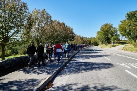 Slovenia, Koper - September 26, 2018: large group of travelers walking along the road in the forest to the entrance of Skocjanske cave in Slovenia near the city of Koperのeditorial素材