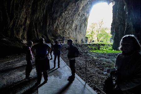 Skocjan caves, Slovenia - September 26, 2019: Guide and tourists near entrance of the Skocjan caves in Slovenia in an autumn dayのeditorial素材