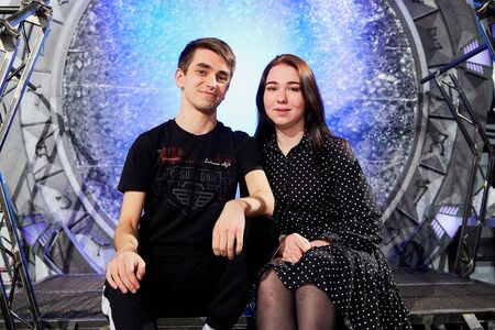 Kirov, Russia - April 18, 2019: Guy and two girls posing on a small stage in a dark hall with beautiful lighting during eventのeditorial素材