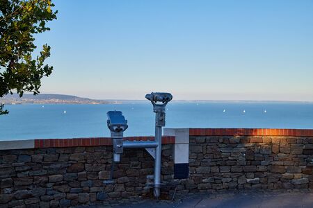 Tihany, Hungary - September 27, 2018: View of the Lake Balaton from Tihany on a sunny day. Tourists on the high shore of lake Balaton at sunsetのeditorial素材