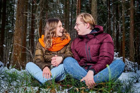 Young pleasant couple in a forest in a winter dayの写真素材