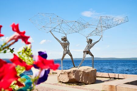 PETROZAVODSK, RUSSIA - JUNE 19, 2019: Sculpture on the embankment of the city of Petrozavodsk in Karelia in Russia on a Sunny summer day. Iron fishermen with a fishing netのeditorial素材
