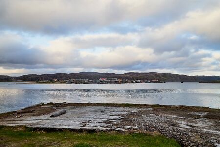 Landscape with a large water village on the opposite shore and sky with clouds. Nature with lake,...