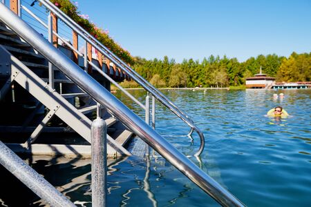 Heviz, Hungary - September 27, 2018: Ladder with railing on alneological therapeutic lake Heviz in Hungary with warm water during all time of a yearのeditorial素材
