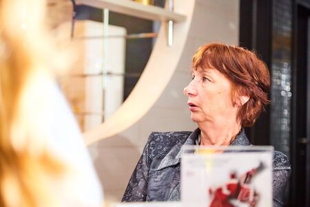 Kirov, Russia - September 17, 2019: People at table in a small cafe or restaurant during intellectual game. Woman waiting for the waiter to get the menu or foodのeditorial素材
