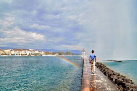 Geneva, Switzeland - September 21, 2018: Pier near famous Jet d'Eau fountain in Geneva lake and tourists on it in a nice day with blue sky and clouds in summer, Canton of Geneva, Switzerlandのeditorial素材