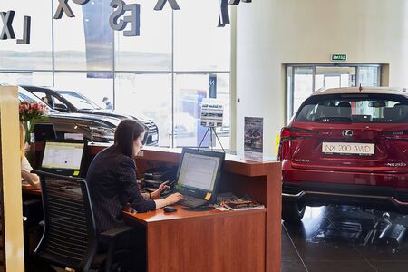 Murmansk, Russia - June 21, 2019: Managers in showroom with cars of dealership Lexus in Murmansk...