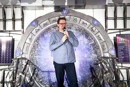 Kirov, Russia - September 25, 2019: Actor performing with microphone on small scene in hall with interesting light. Handsome manのeditorial素材