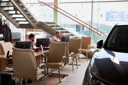 Vologda, Russia - June 18, 2019: Manager in showroom with cars of dealership Nissan in Vologda city in Russiaのeditorial素材