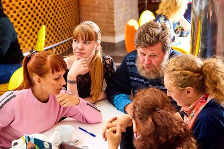 Kirov, Russia - September 17, 2019: People at table in small cafe or restaurant during intellectual...