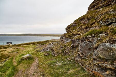 Norway landscape with rocky shore of the Northern sea in cloudy weather in a summer, spring or autumn dayの写真素材