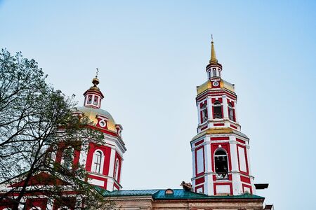 Tower, dome and cross of the traditional Russian Orthodox Church and blue sky in the background