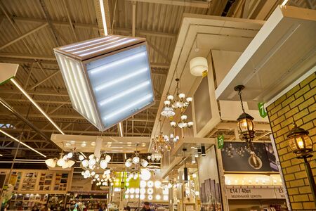 Kirov, Russia - November 23, 2019: Lamps, chandeliers and sconces on the ceiling of the big store Leroy Merlin with goods for homeのeditorial素材