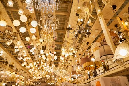 Kirov, Russia - November 23, 2019: Lamps, chandeliers and sconces on the ceiling of the big store Leroy Merlin with goods for homeのeditorial素材