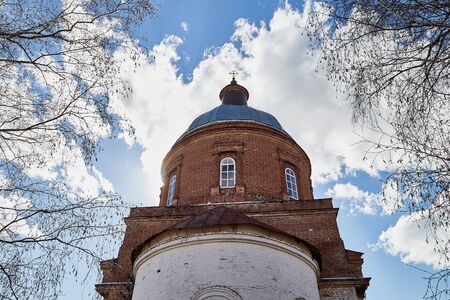 Traditional old russian church with domes in nature landscape in a nice day and sky with clouds background. Architecture in the Orthodox religionの写真素材
