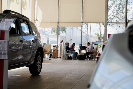 Vologda, Russia - June 18, 2019: Manager in showroom with cars of dealership Nissan in Vologda city in Russiaのeditorial素材